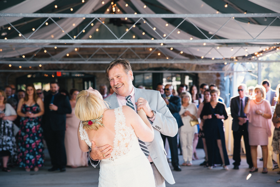 bride and her father laughing during father daughter dance