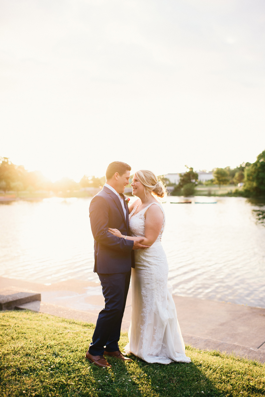 portrait of bride and groom smiling at each other at sunset