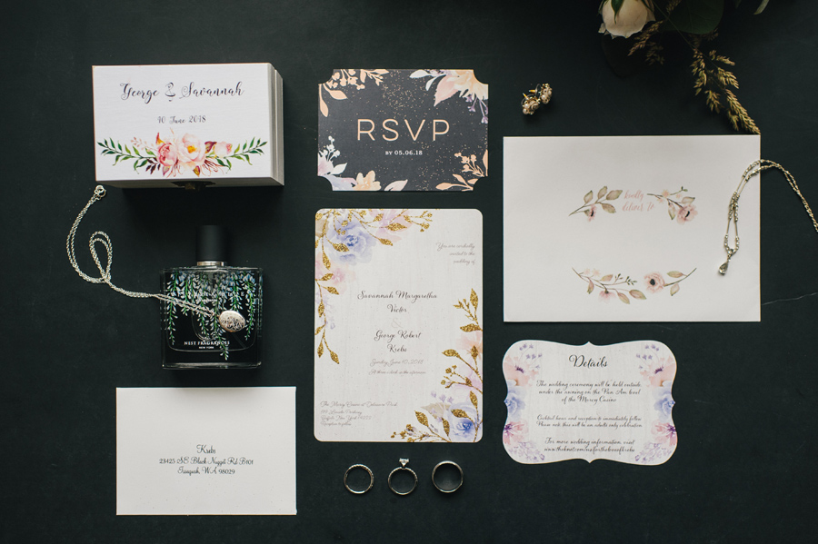 wedding invitation suite with perfume bottle and jewelry