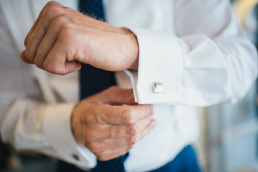 groom adjusting his cuff link