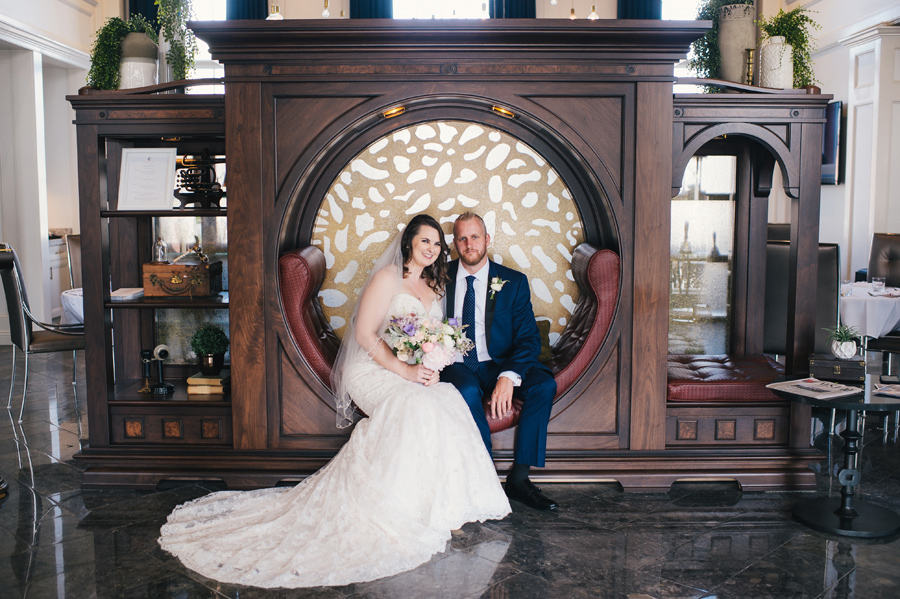 bride and groom posing in the lobby of the reikart house hotel