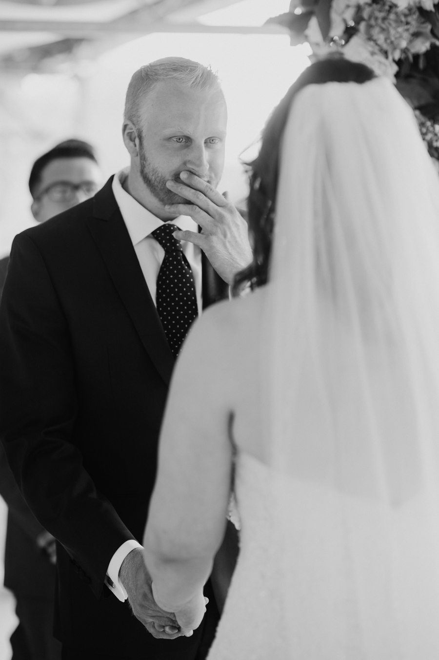 black and white photo of groom looking lovingly at the bride