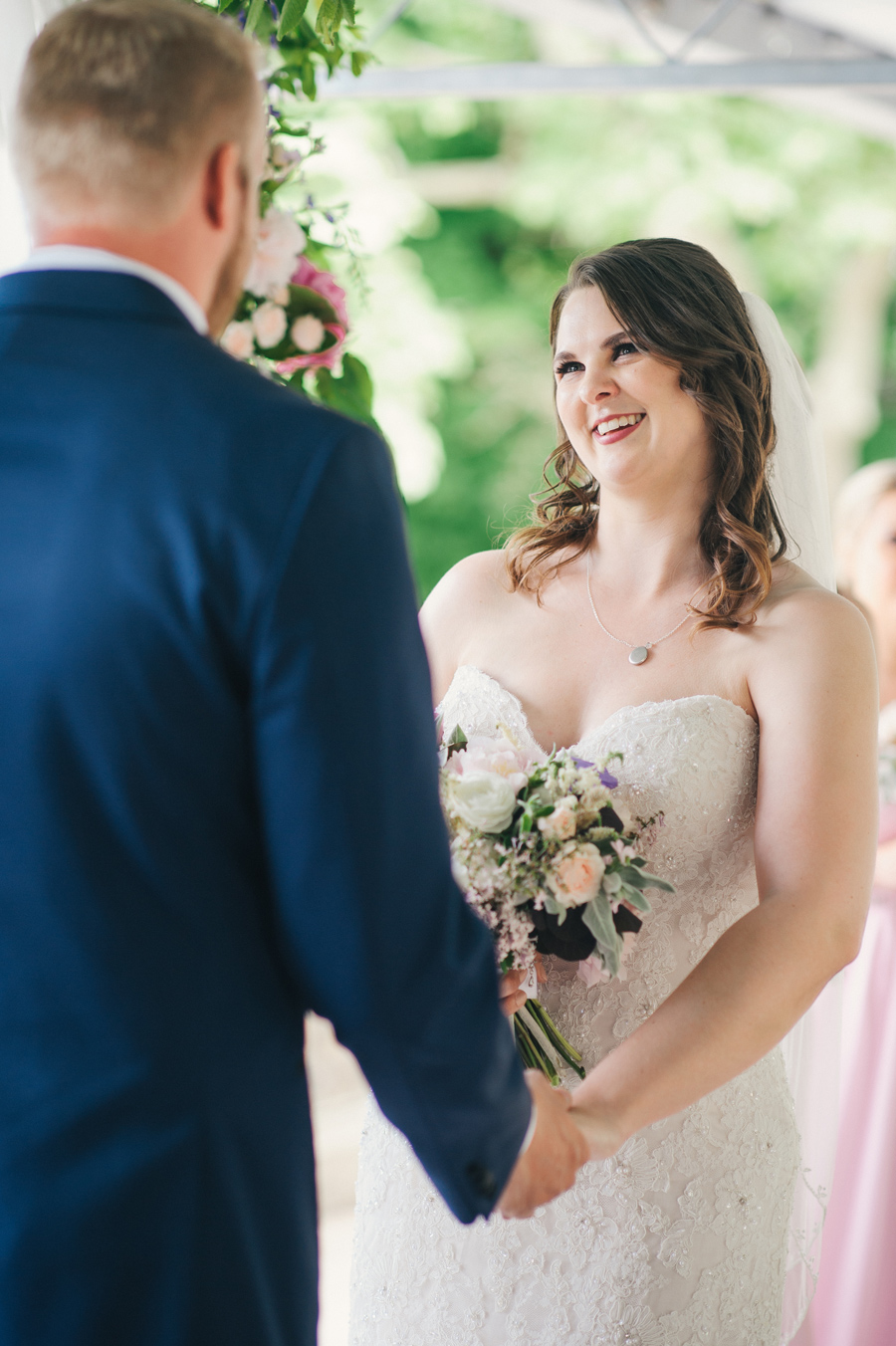 bride smiling at the groom during the ceremony