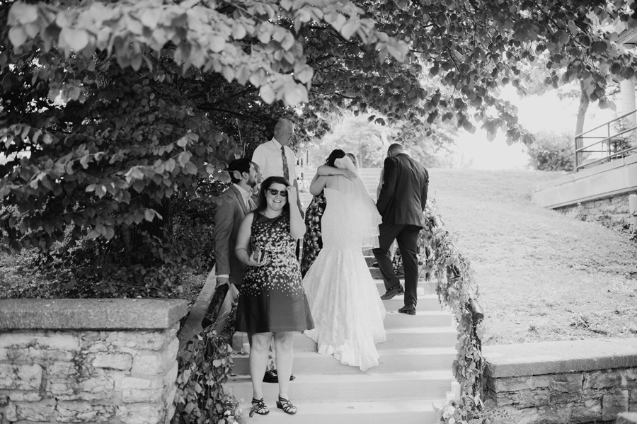 black and white of bride hugging a wedding guest