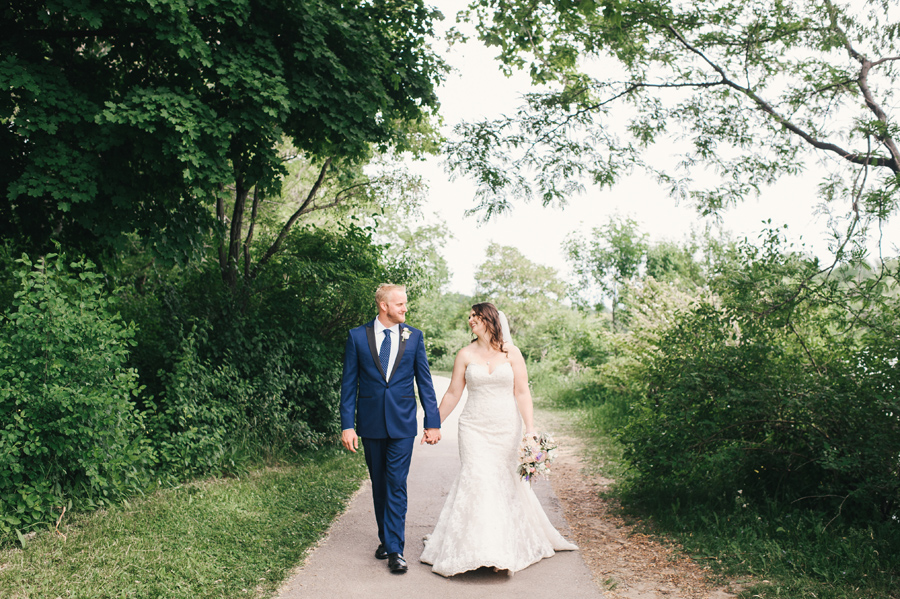 bride and groom strolling hand in hand through delaware park