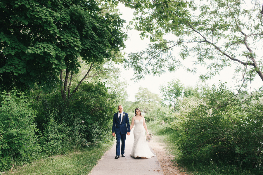 bride and groom walking the path together through delaware park