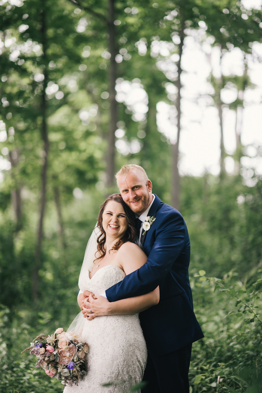 bride and groom posing together in delaware park