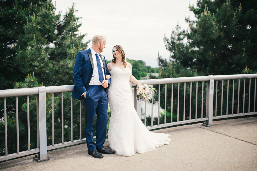 bride and groom smiling at each other at the park