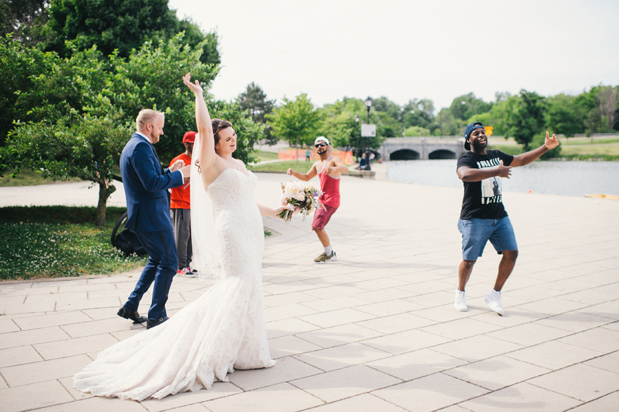 bride and groom dancing with people at the park near hoyt lake