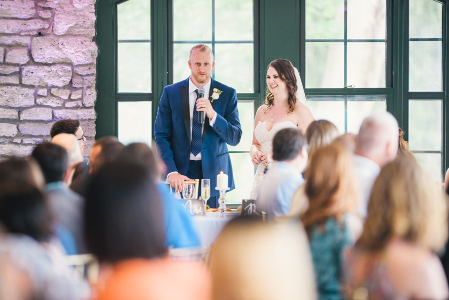 bride and groom giving speech of thanks to wedding guests