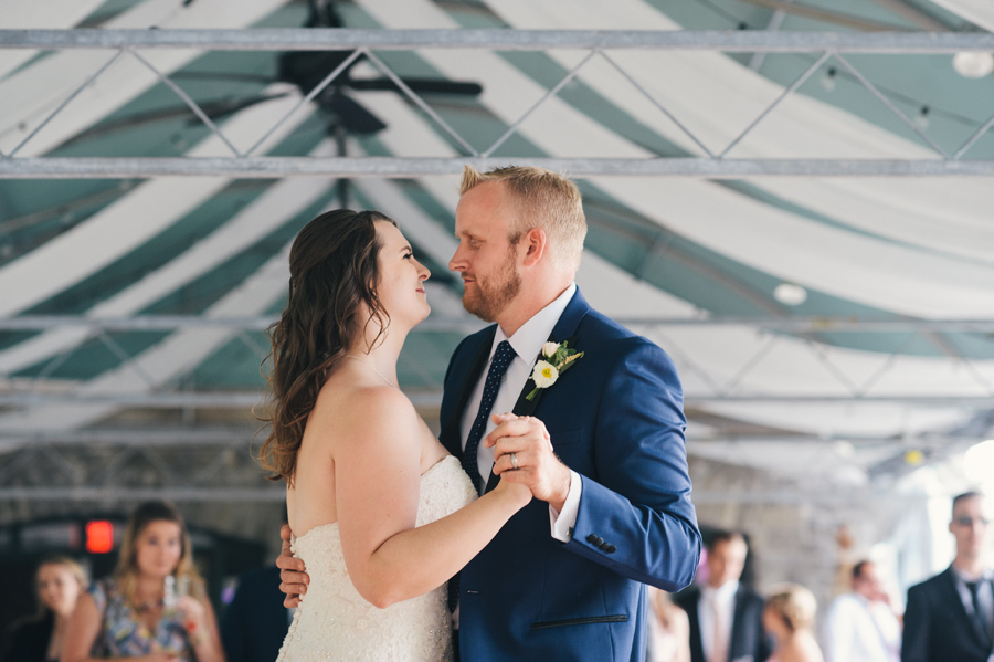 bride and groom dancing under patio tent outside marcy casino