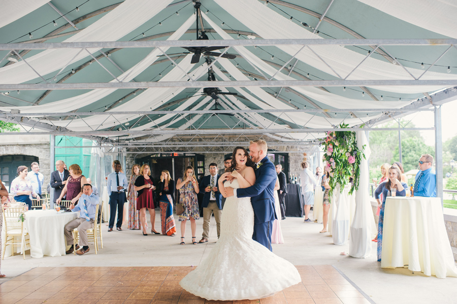 groom twirling bride during first dance