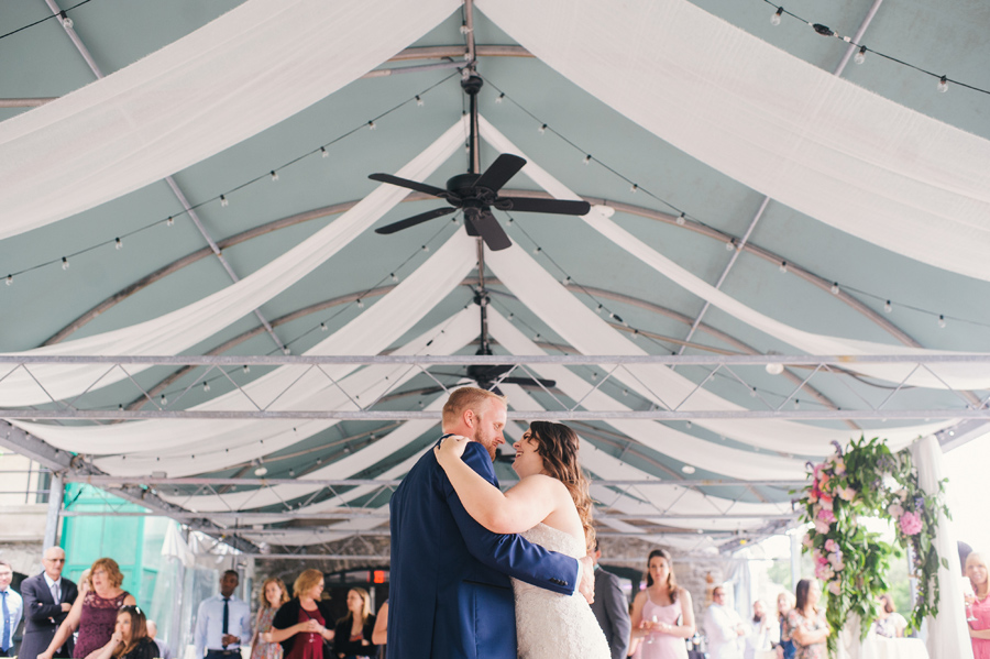 bride and groom laughing together during first dance