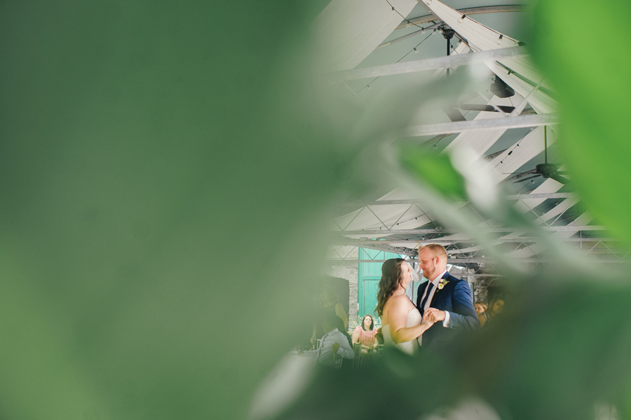 shot of bride and groom dancing through leaves