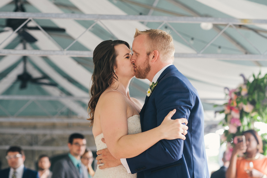 bride and groom kissing during first dance together