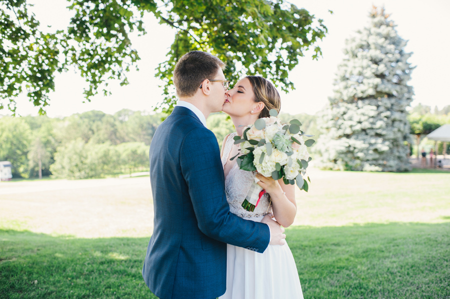 bride and groom kissing during their first look on wedding day