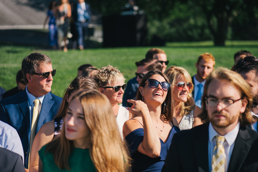 wedding guests enjoying the sun while waiting for the ceremony to start