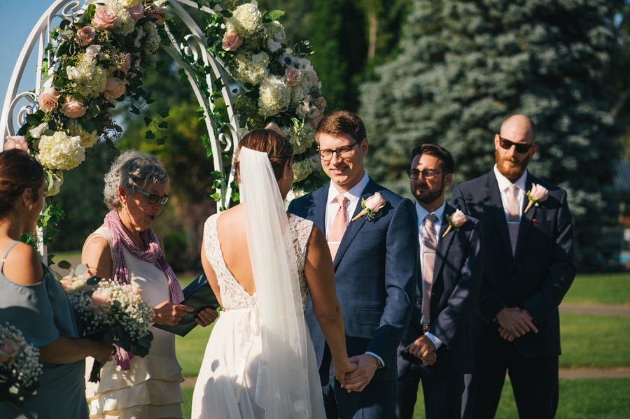 groom smiling at the bride during the outdoor wedding ceremony