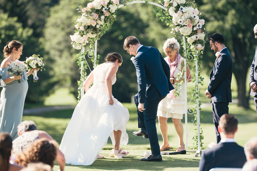 bride and groom stomping the glass after their jewish wedding ceremony