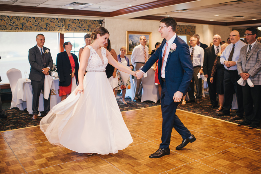 groom twirling the bride during their first dance