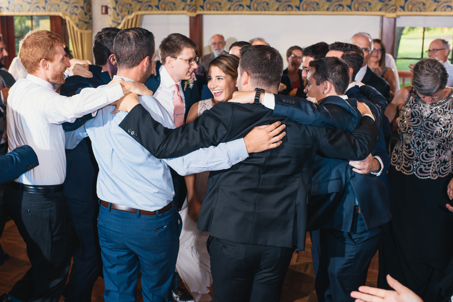 wedding guests circling around bride and groom on the dance floor