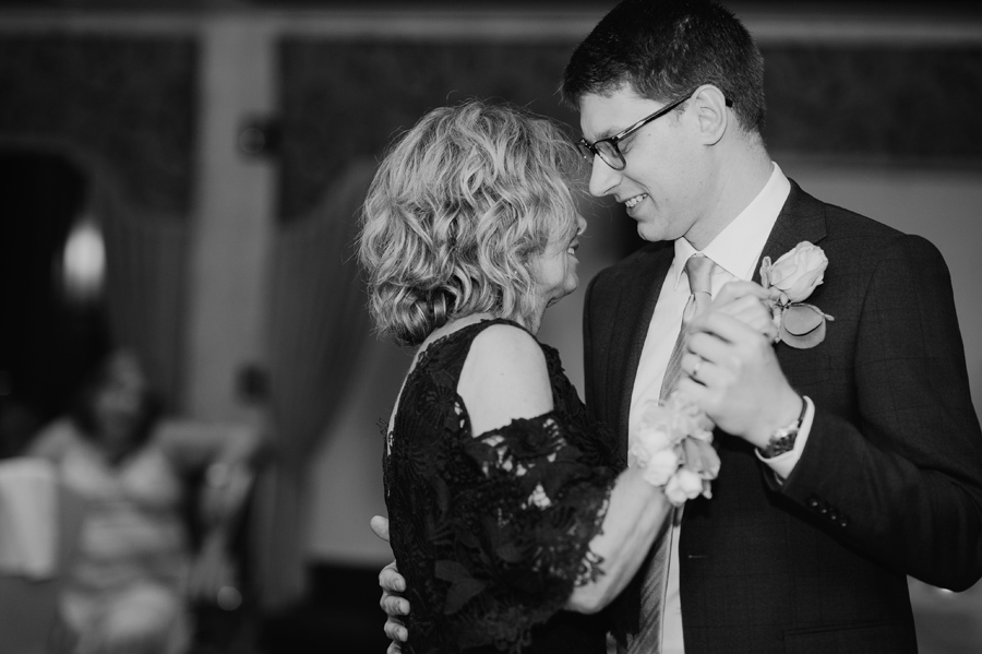 black and white of groom dancing with his mother