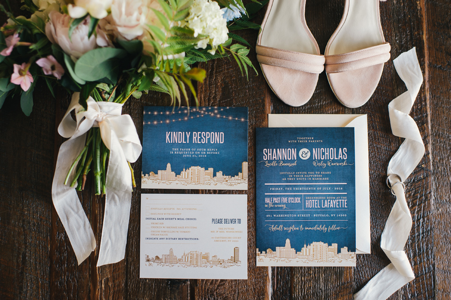 detail shot of invitation suite with bridal bouquet and shoes