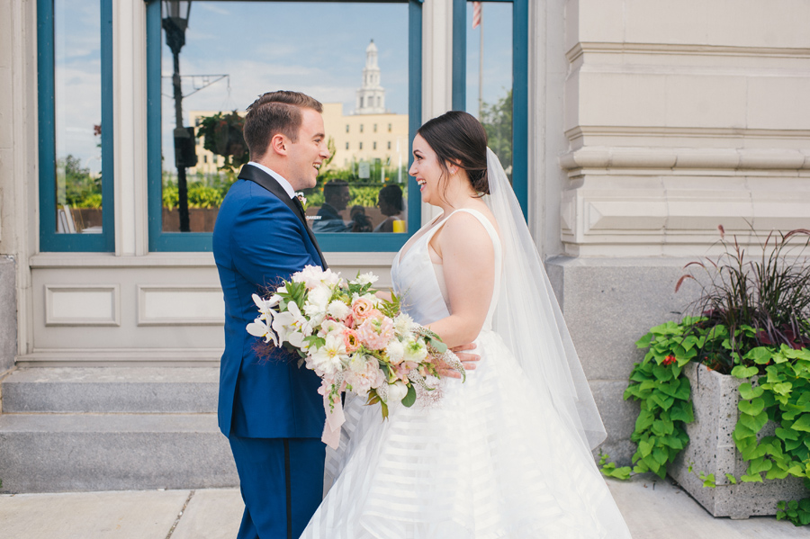 bride and groom smiling at each other during their first look