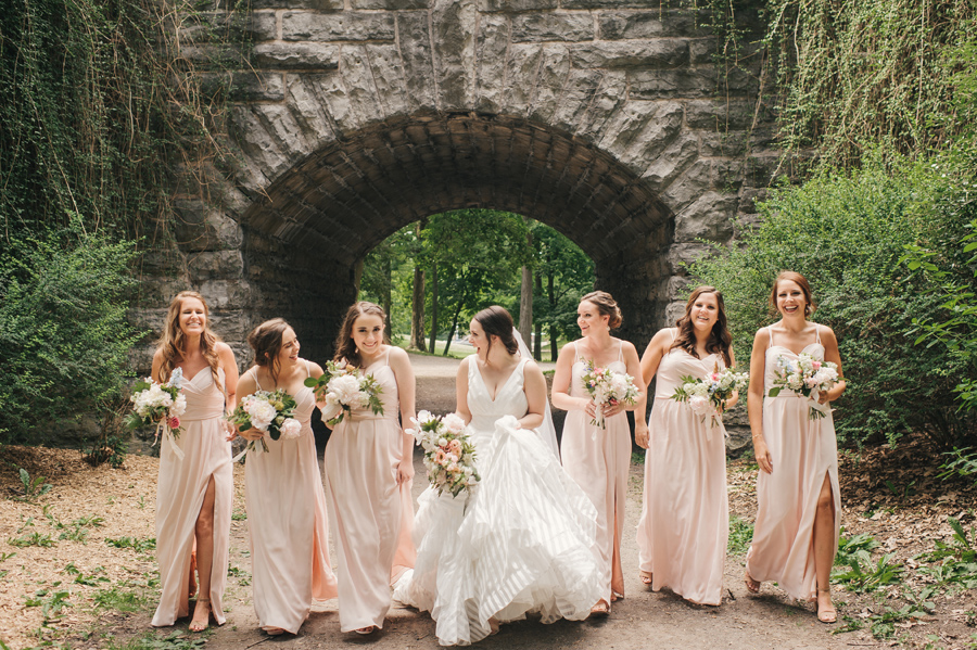 bridal party laughing with each other and walking towards camera