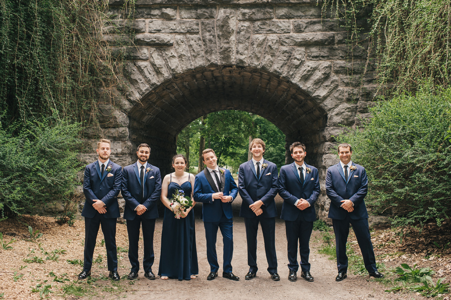 groom with his groomsmen and best person in a park