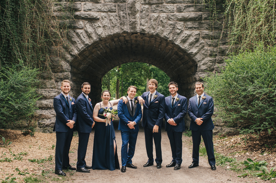 full length of groom and groomsmen acting casual for the camera