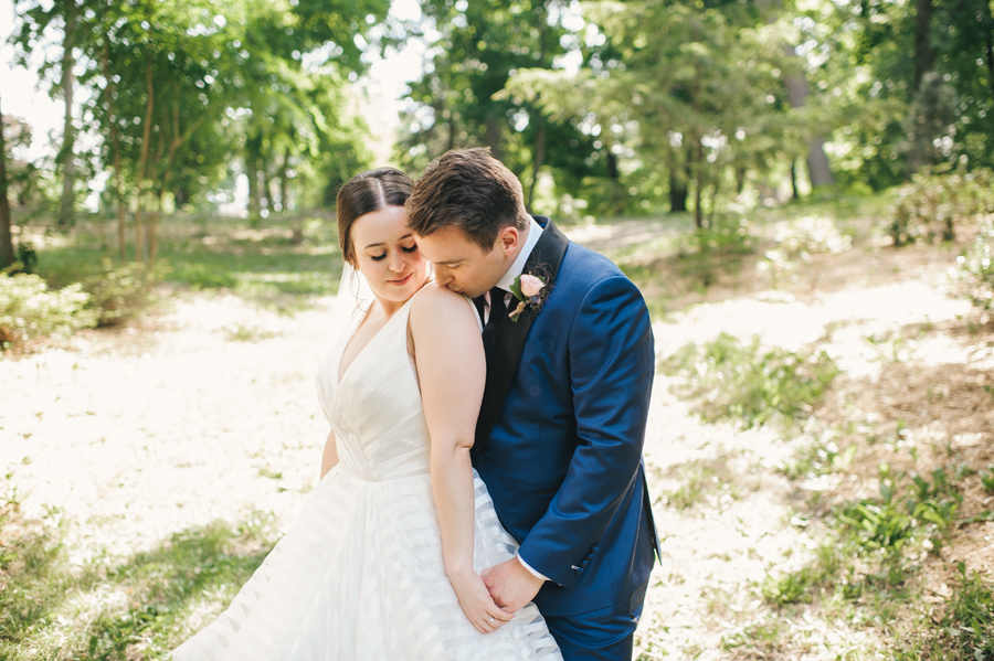 groom kissing the bride's shoulder