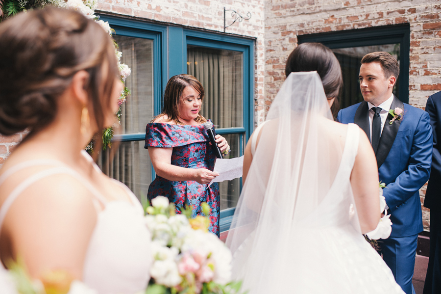 mother of the bride doing a reading during the ceremony