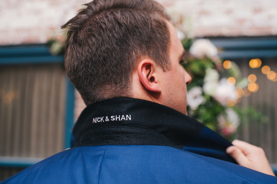 Nick & Shan embroidered underneath the groom's suit jacket collar