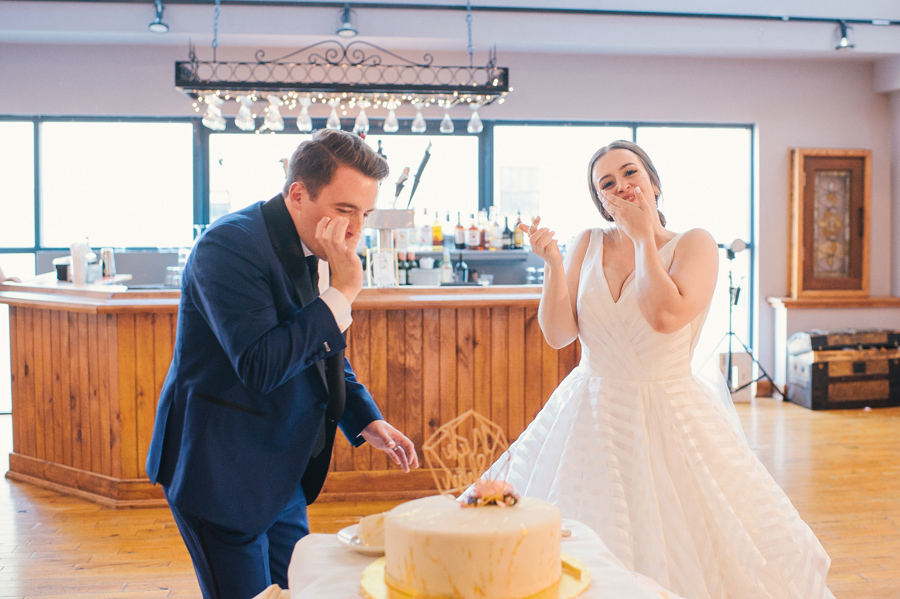 bride and groom tasting their wedding cake together