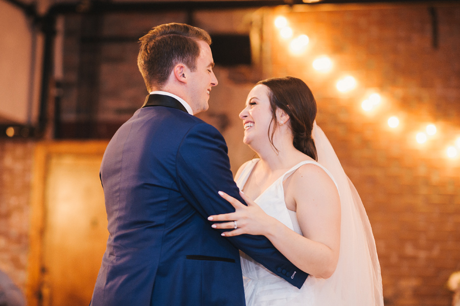 bride and groom smiling at each other during their first dance