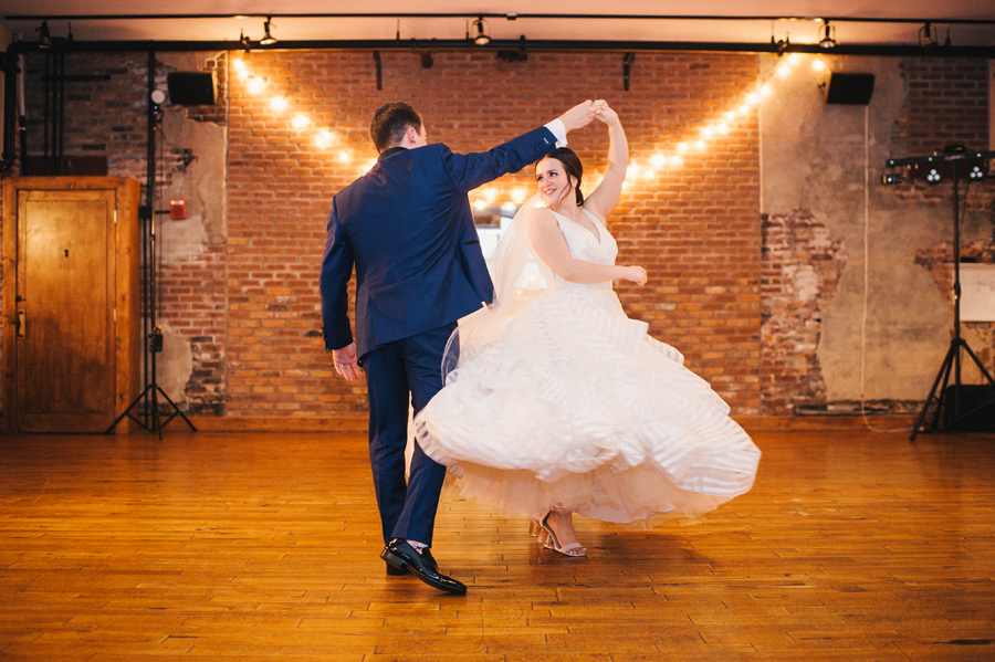 groom twirling his bride during their first dance