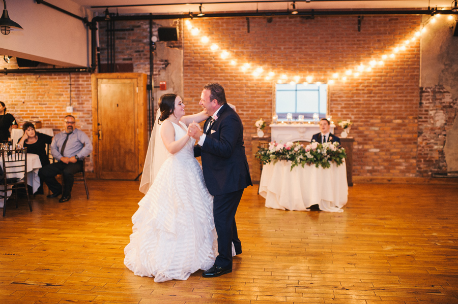 bride and her father dancing together during the wedding reception