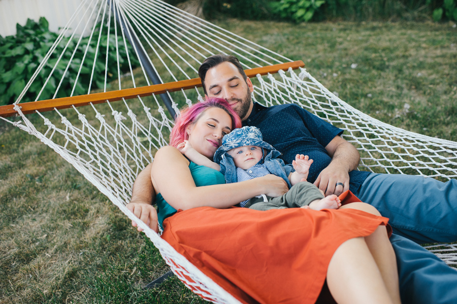 family laying together in a hammock