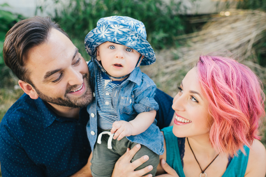 baby boy looking at camera and parents smiling at each other