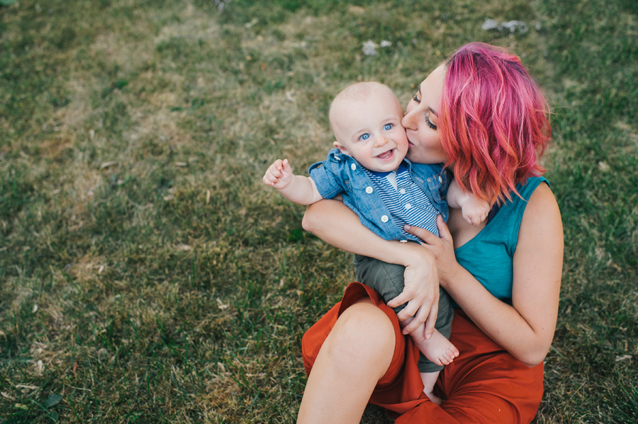 mom holding baby and kissing his cheek