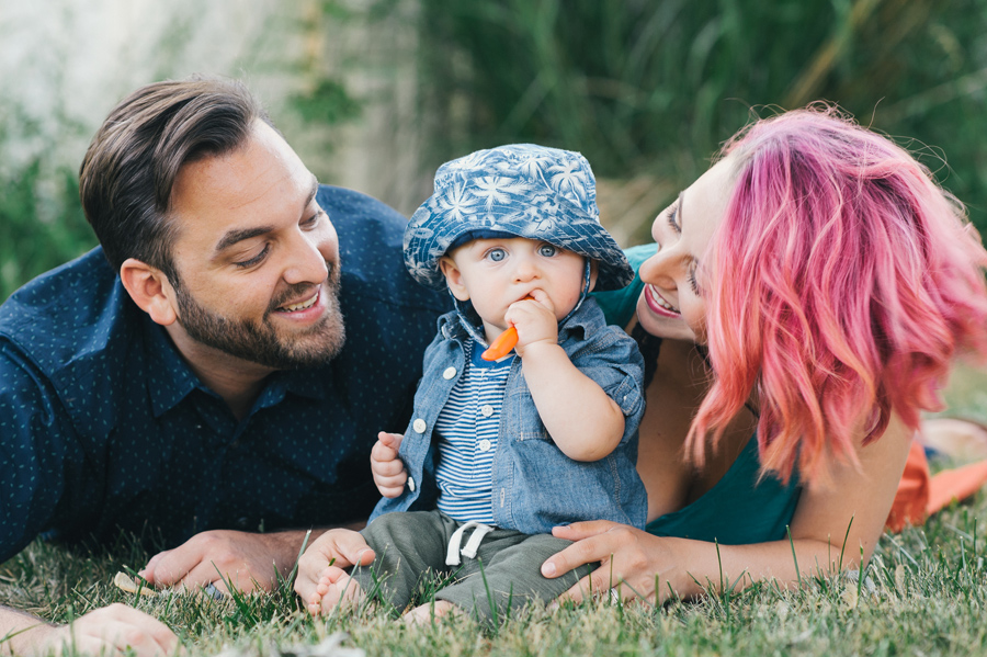 family laying in the grass together