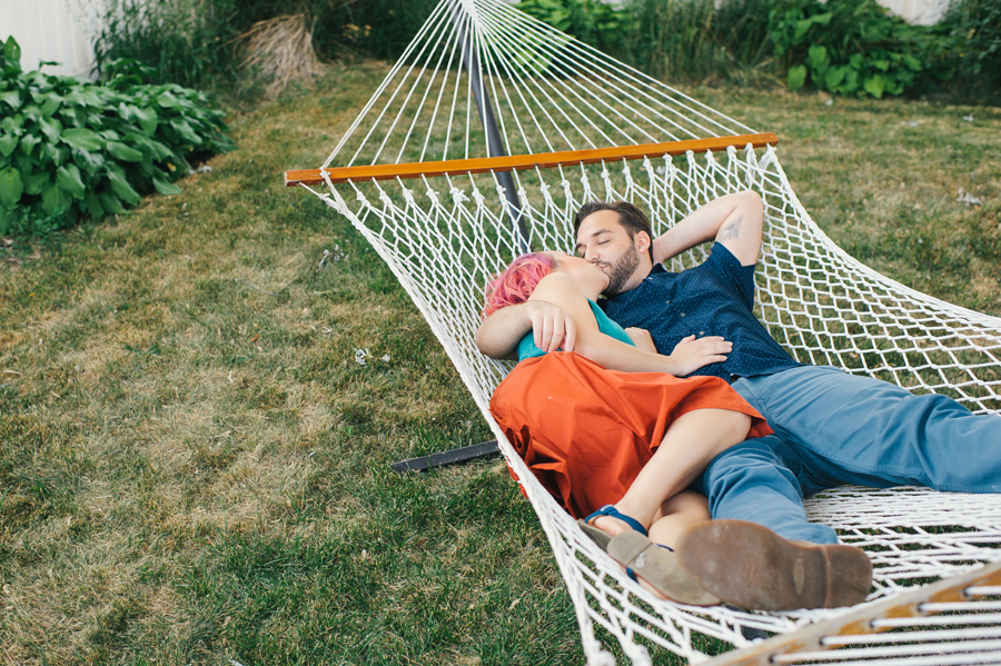 husband and wife kissing in hammock