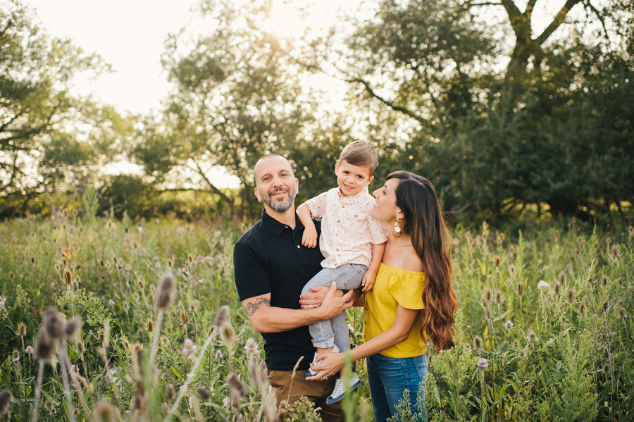 family in a field at sunset